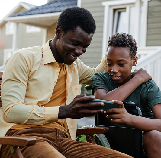 Father and son looking at a phone